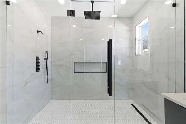 a bathroom with a tub a sink and mirror