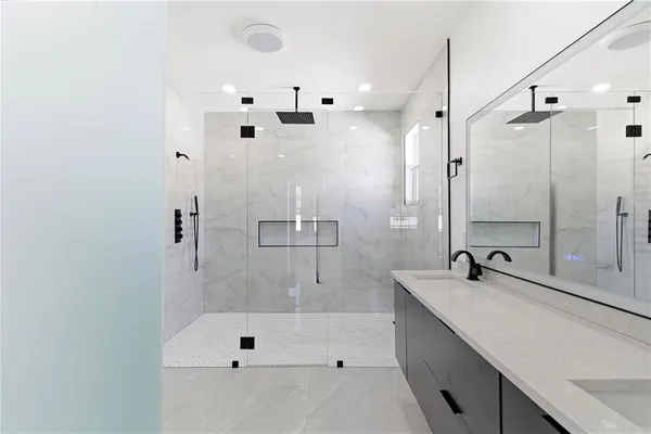 a bathroom with a glass shower door