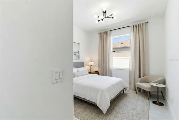 a bedroom with a bed and a table in it