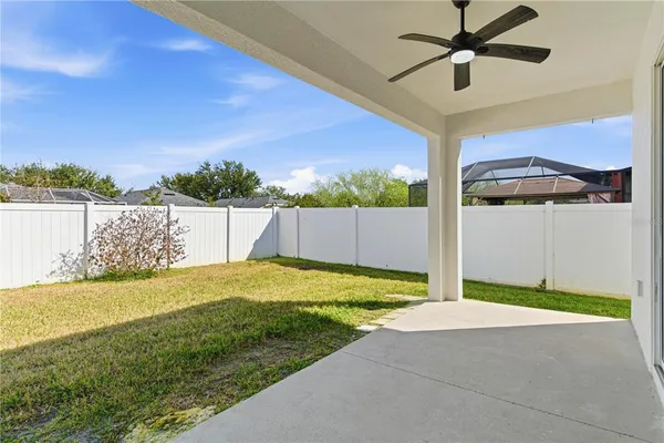 a aerial view of a house with a yard and potted plants
