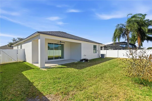 a view of a swimming pool with a lawn chairs under an umbrella