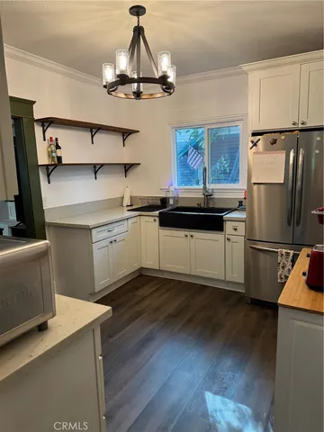 a kitchen with stainless steel appliances a sink a stove a refrigerator and island