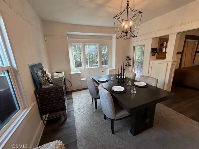 a view of a dining room with furniture wooden floor chandelier