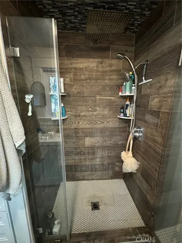 a view of backyard with wooden fence and large trees