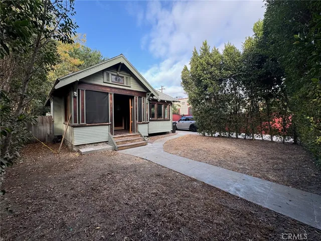 a view of a balcony with chairs and wooden floor