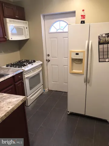 a kitchen with a refrigerator sink and stove