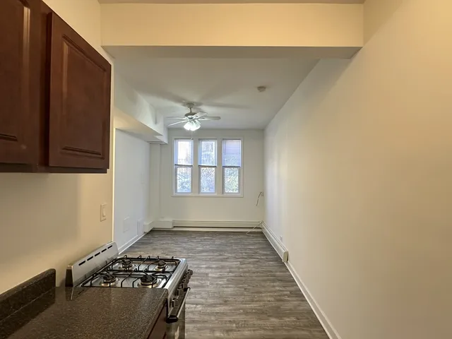 a view of wooden floor and a window in a room