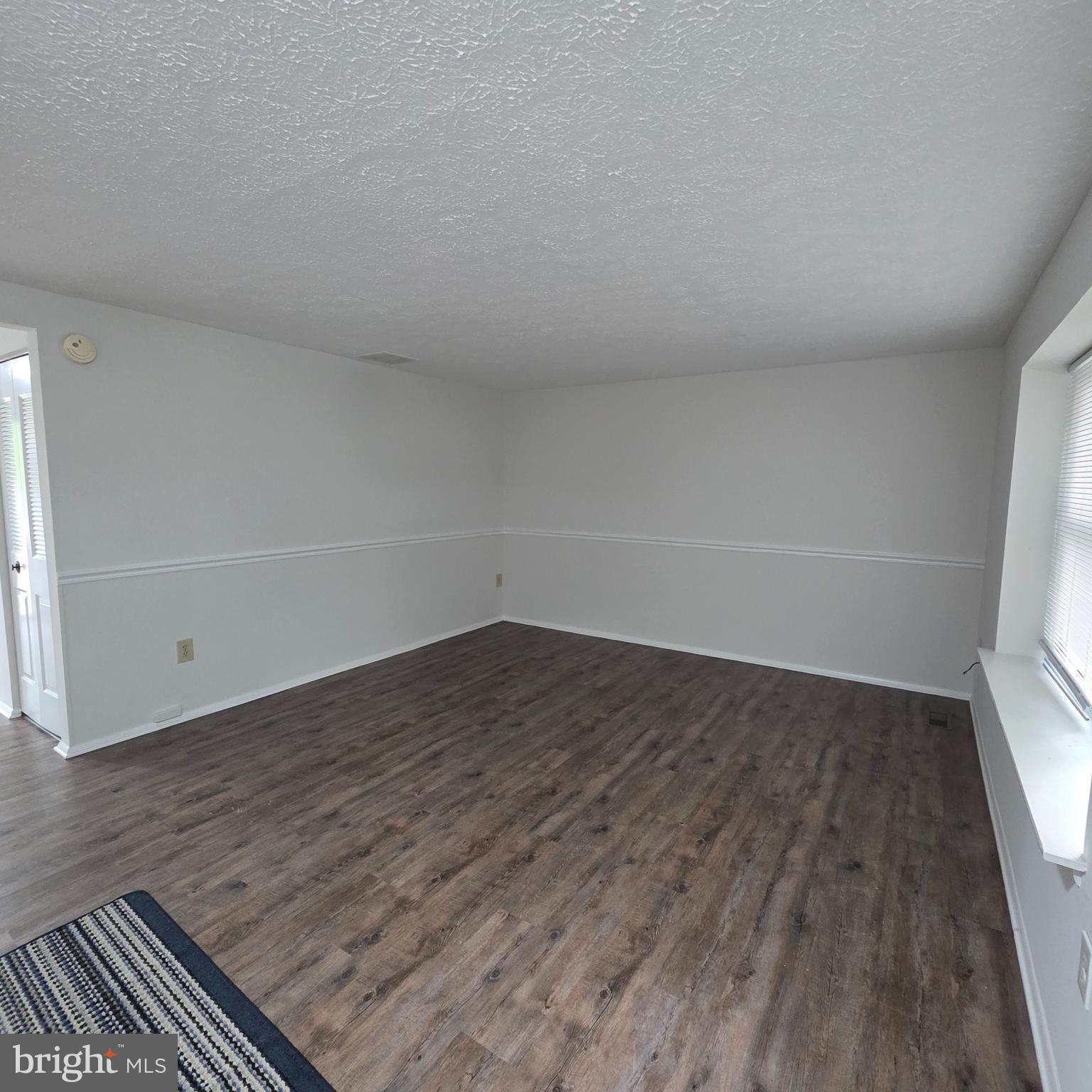 1758 Springfield Lane Frederick, MD 21702 - Photo 4 of 31 a view of an empty room and wooden floor