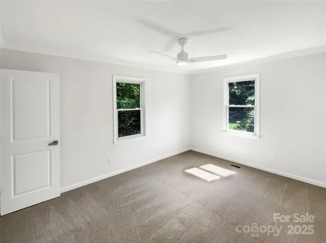 an empty room with windows and closet