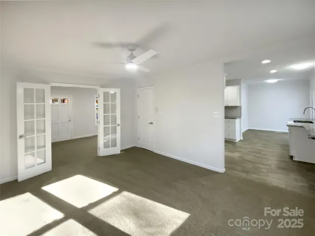 a view of livingroom with hardwood floor and a ceiling fan