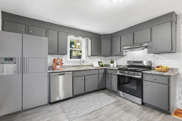 a kitchen with a sink cabinets and stainless steel appliances