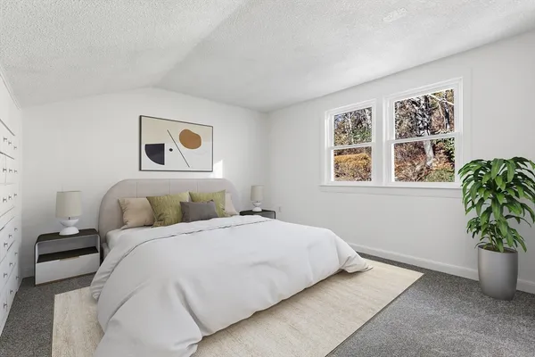 a bedroom with a bed and a potted plant