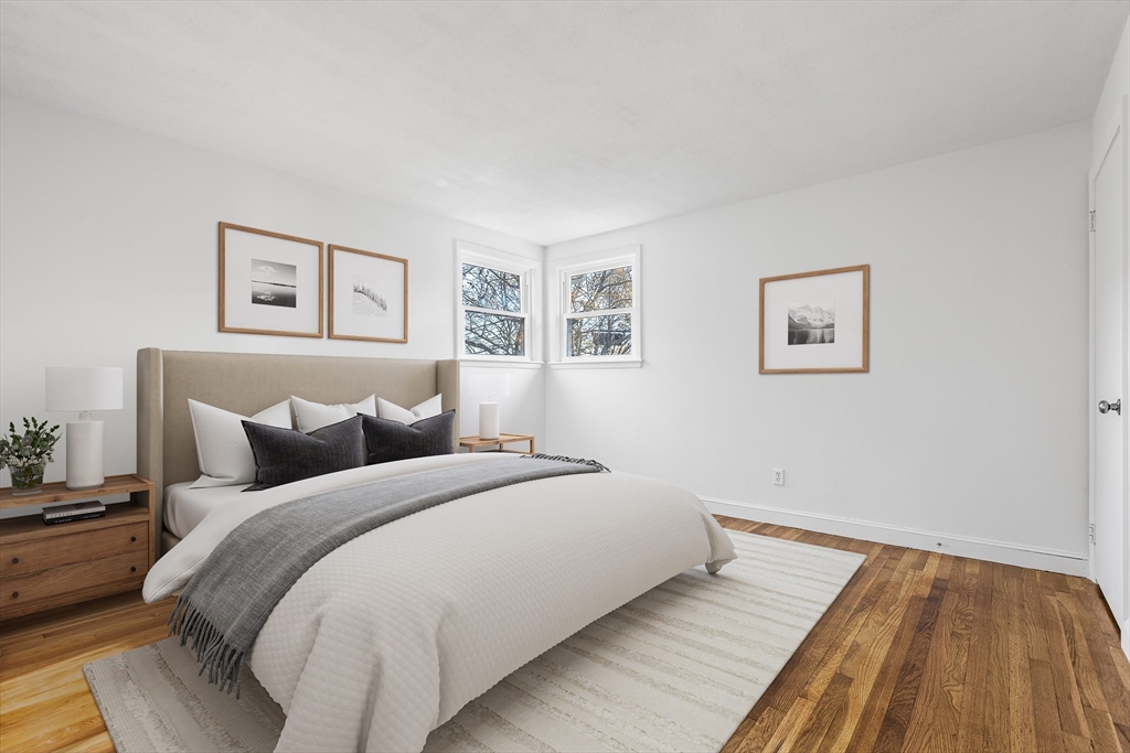 73 Lockwood Road Lynn, MA 01904 - Photo 7 of 10 a bed room with a bed and painting on the wall