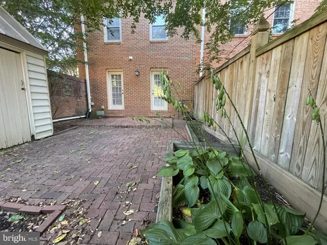 a front view of a house with a yard and plant