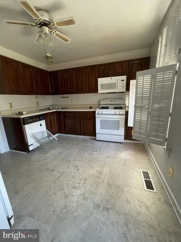 a kitchen with a refrigerator and a stove