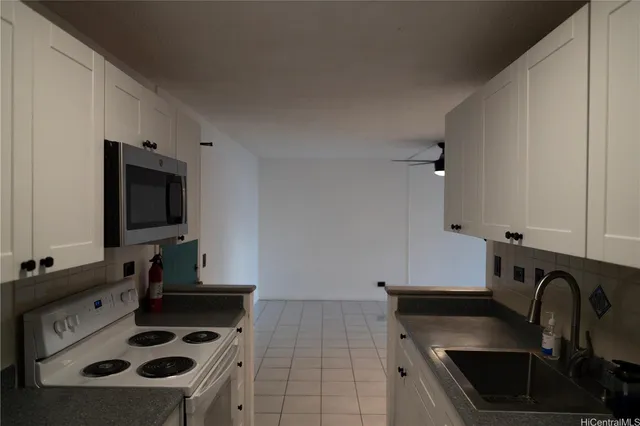 a kitchen with stainless steel appliances a sink a stove and a microwave oven