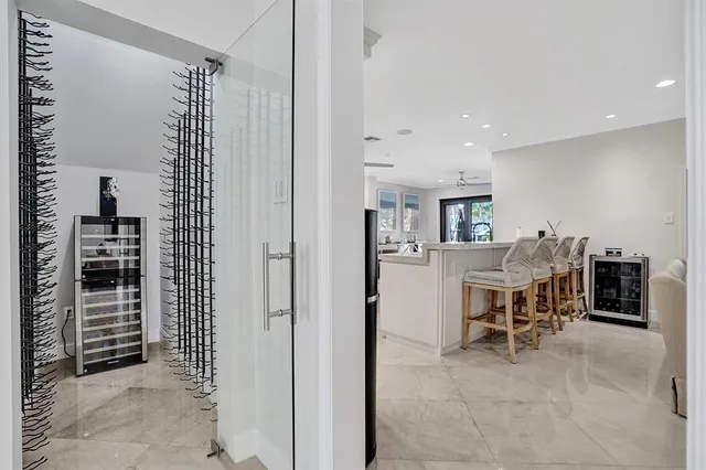 a living room with furniture and kitchen view