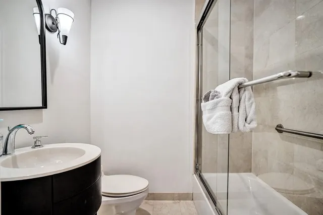 a view of hallway with stairs and wooden floor