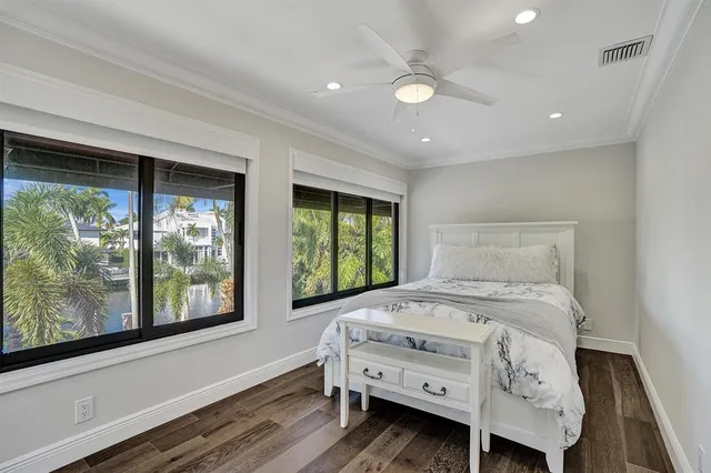 a living room with furniture and potted plants