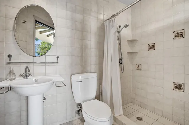 a view of a swimming pool with a yard and palm trees