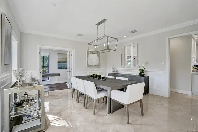 a living room with furniture a rug and white walls