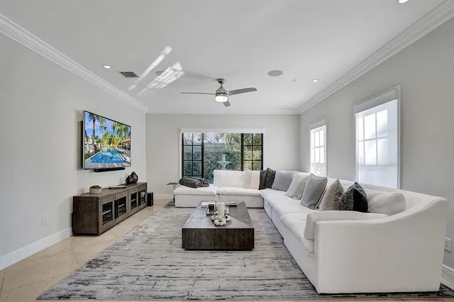 a living room with furniture a rug and a window