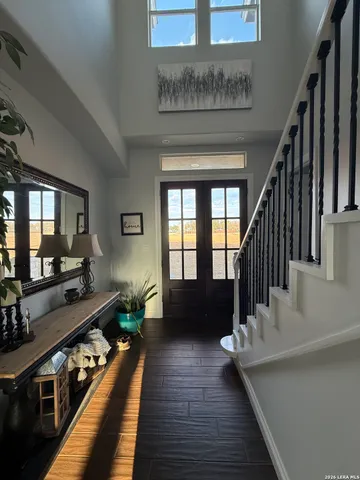 a hallway with wooden floor and furniture