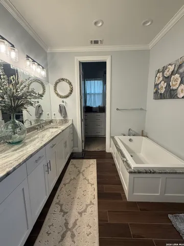 a bathroom with a double vanity sink and mirror