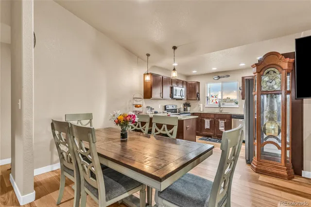 a view of a dining room with furniture and wooden floor