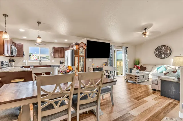 a view of a dining room with furniture and a kitchen