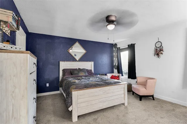 a bedroom with a bed and a potted plant