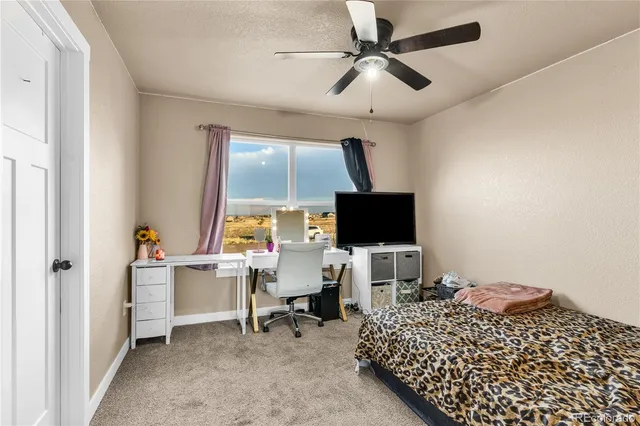 a bedroom with a workspace