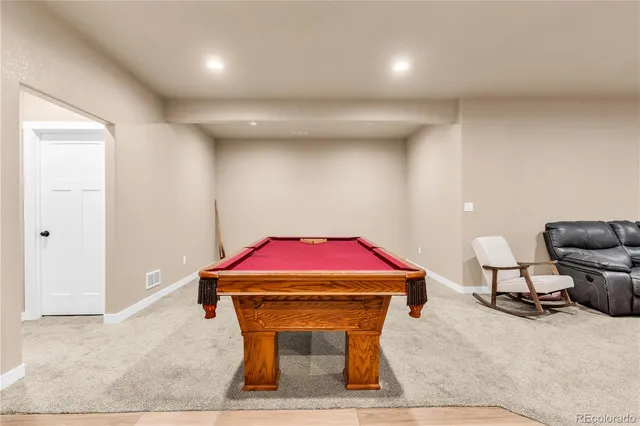a room with furniture and air hockey table