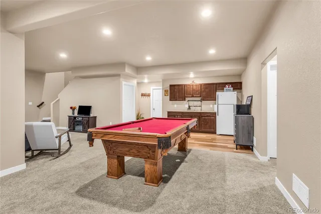 a room with pool table and furniture