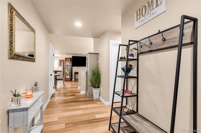 a hallway with wooden floor and furniture