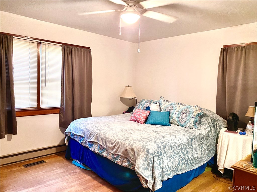 2825 Blackstone Road Kenbridge, VA 23944 - Photo 7 of 20 a bedroom with a bed lamp on desk and a window