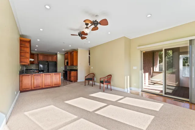 a living room with furniture and kitchen view