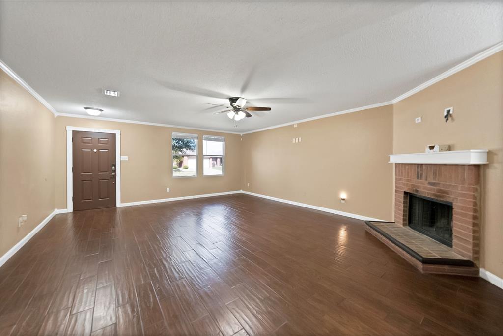 4021 German Pointer Way Fort Worth, TX 76123 - Photo 13 of 38 a view of an empty room with window and wooden floor