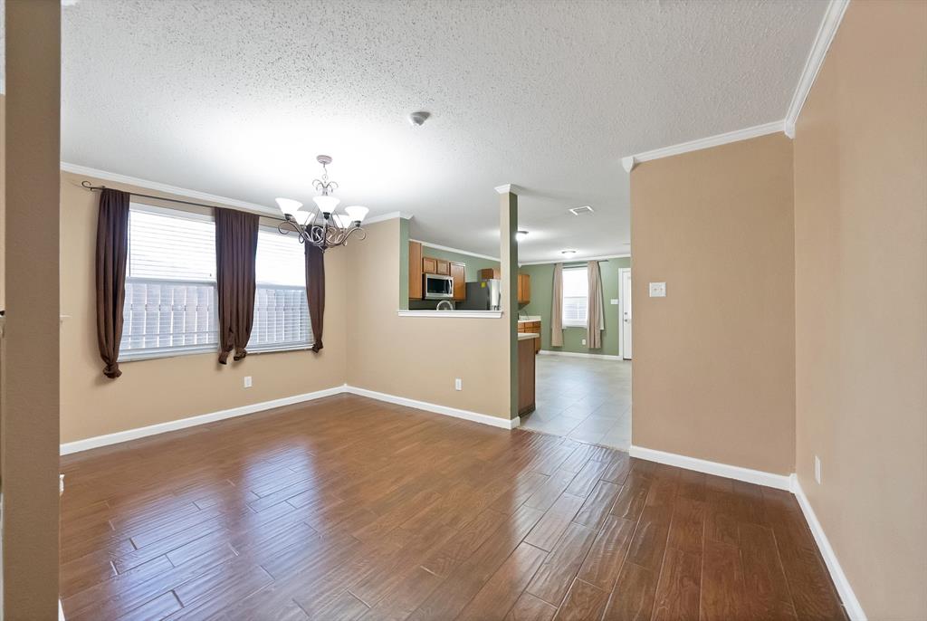 4021 German Pointer Way Fort Worth, TX 76123 - Photo 14 of 38 an empty room with wooden floor and windows