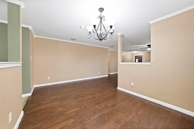 a view of a room with wooden floor