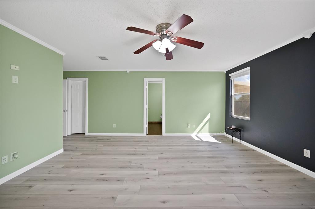 4021 German Pointer Way Fort Worth, TX 76123 - Photo 29 of 38 a bedroom with a large bed and a chandelier