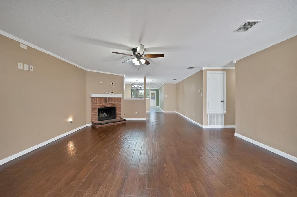 4021 German Pointer Way Fort Worth, TX 76123 - Photo 10 of 38 a view of an empty room with a fireplace and a chandelier fan