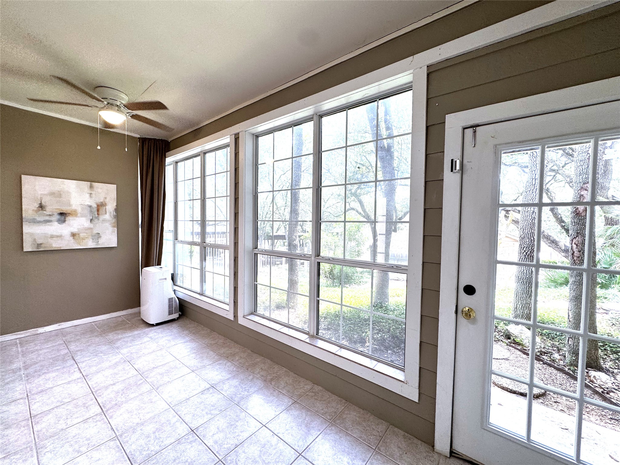3809 Spicewood Springs Road, Unit 137 Austin, TX 78759 - Photo 26 of 34 A bright sunroom features large windows overlooking the natural landscape with access to the Pool!