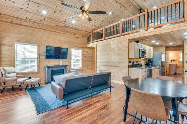 a living room with fireplace furniture and a wooden floor