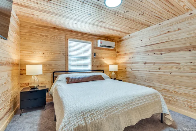 a bedroom with a bed and a night stand