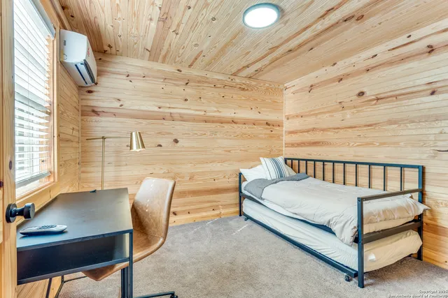 a bedroom with a bed and with chair