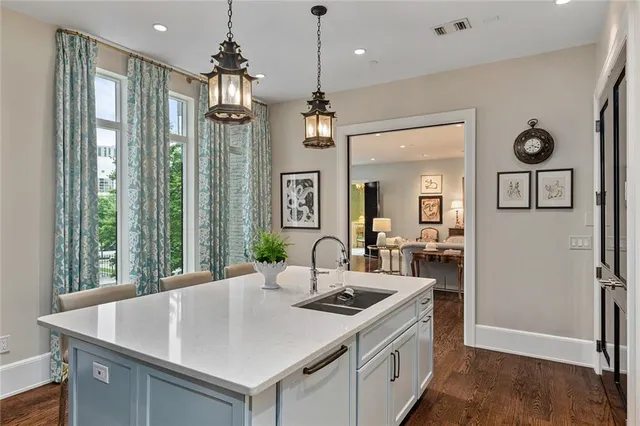 a kitchen with stainless steel appliances granite countertop a sink and a refrigerator