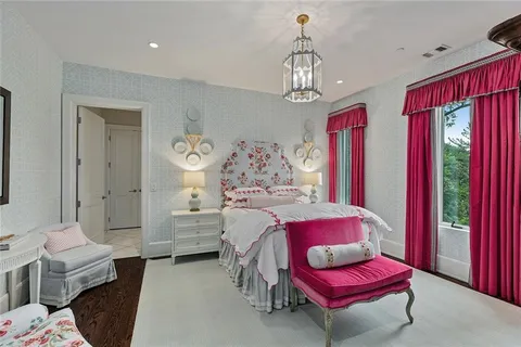 a bed room with a bed and a chandelier