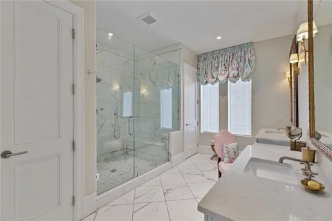 a spacious bathroom with a shower and a sink