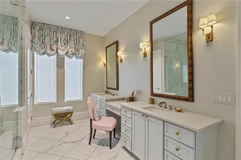 a bathroom with double sink and a mirror